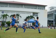 Soccer players running on SSIS field